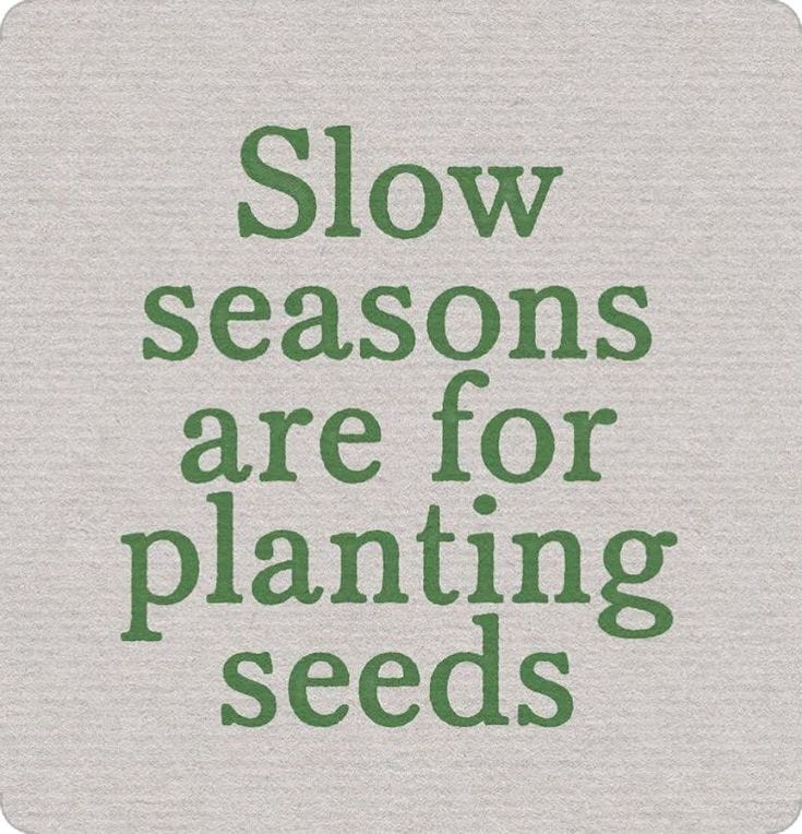 This may contain: the words slow seasons are for planting seeds on a gray background with green lettering that reads,