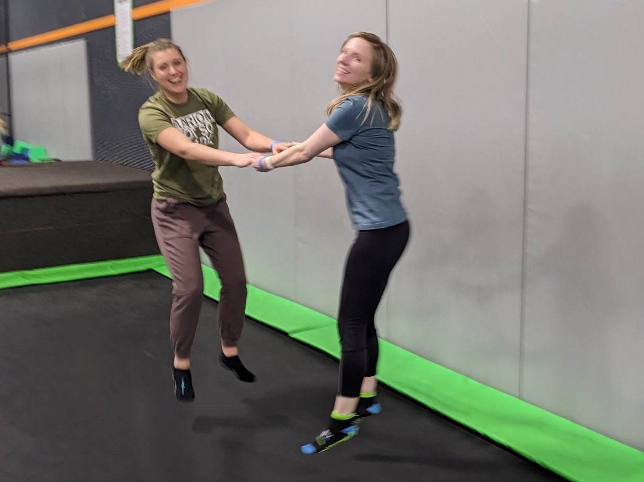 Two women jumping on a trampline