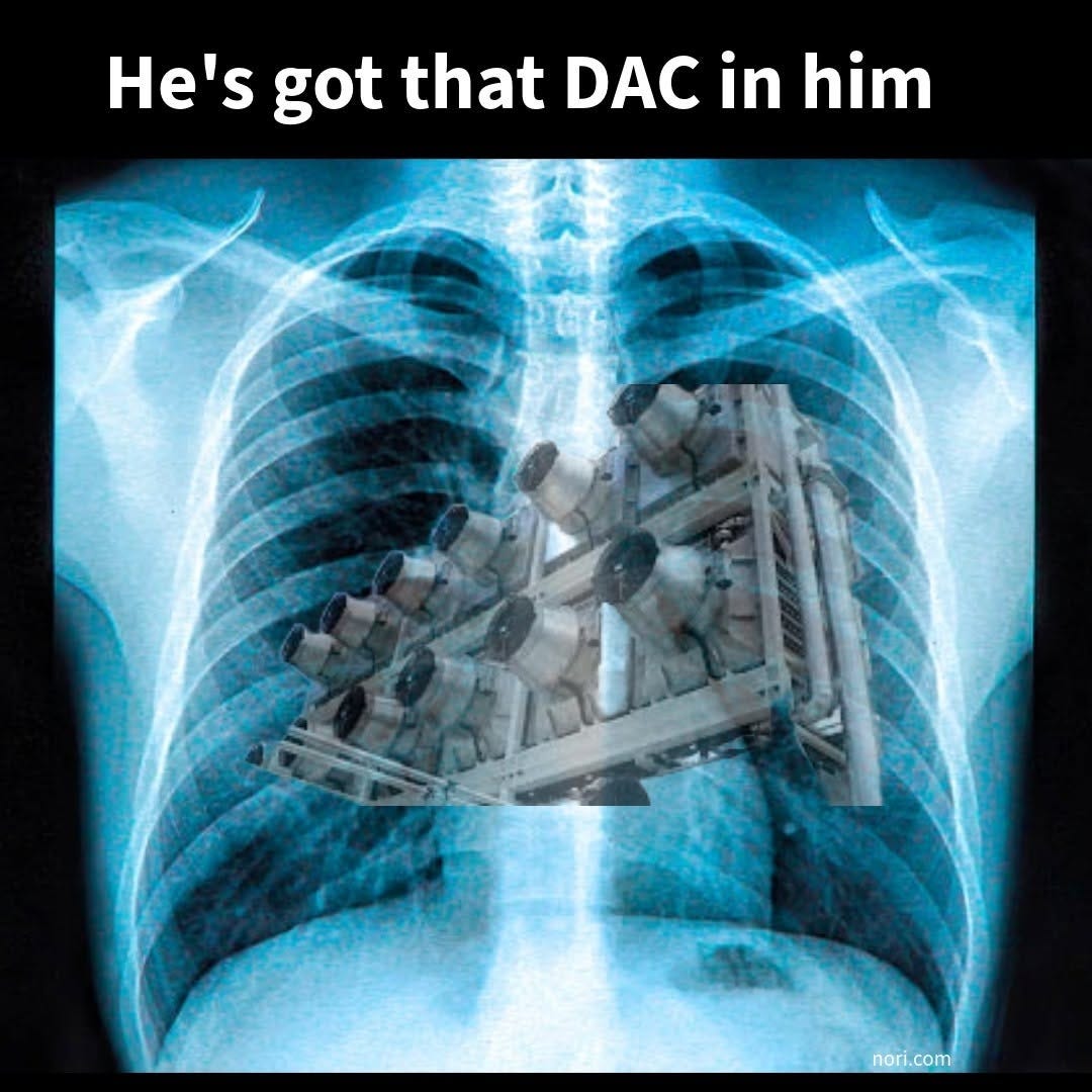 A chest X-ray with a direct air capture machine pasted between the lungs, under the text "He's got that DAC in him".