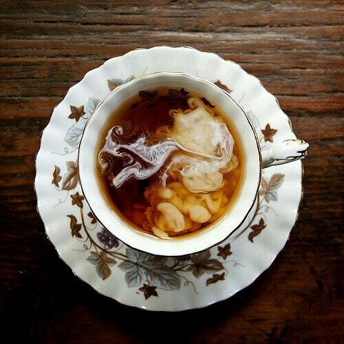 This may contain: a bowl filled with soup sitting on top of a wooden table