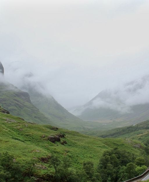 The Three Sisters of Glencoe in the Scottish Highlands, shrouded in mist and low cloud
