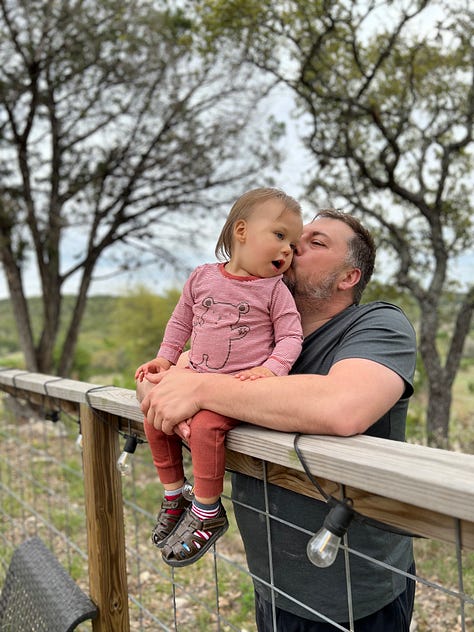 Han is sitting on a fence and Mike is holding him. They are having many sweet, affectionate, silly moments.