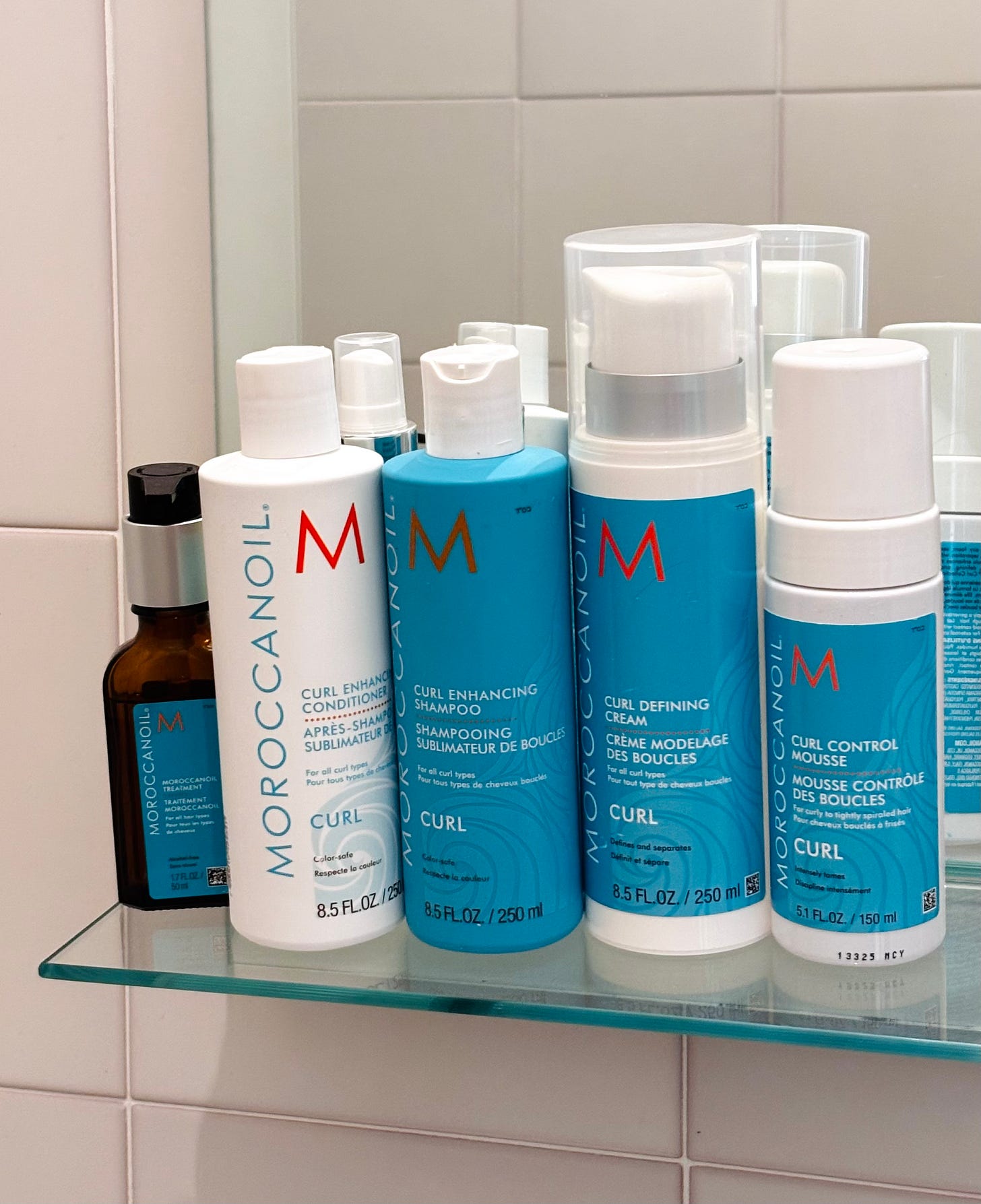 A picture of the Moroccan Oil Hair Products on a bathroom shelf A picture of the Moroccan Oil Hair Products on a bathroom shelf