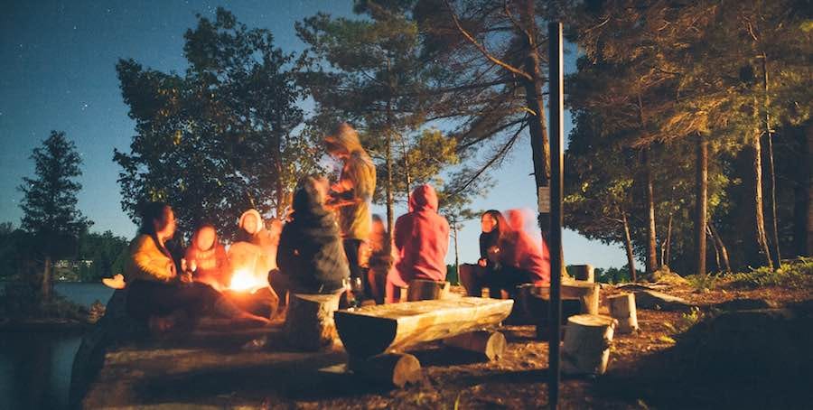Group sitting around campfire