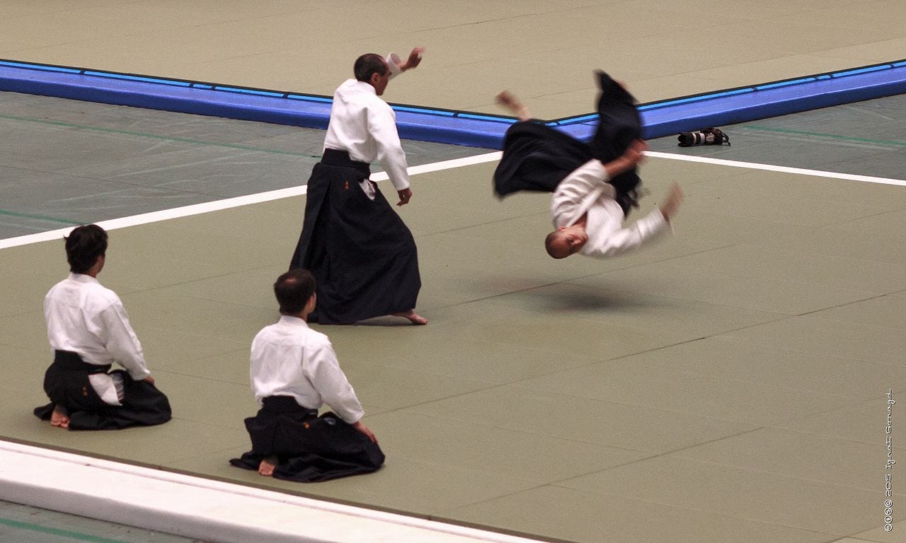 https://upload.wikimedia.org/wikipedia/commons/thumb/c/c7/Tada_Hiroshi_9th_Dan_Shihan_-_53rd_All_Japan_Aikido_Demonstration_at_Nihhon_budokan_%2822861843409%29.jpg/1280px-Tada_Hiroshi_9th_Dan_Shihan_-_53rd_All_Japan_Aikido_Demonstration_at_Nihhon_budokan_%2822861843409%29.jpg