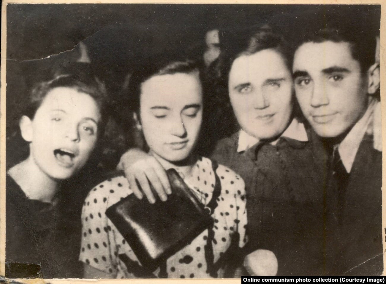 A young Elena Ceausescu (center left) with friends at a ball.