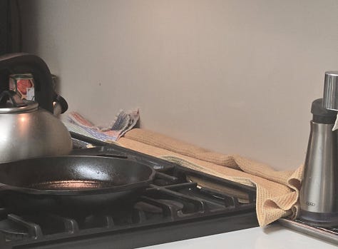 Three side-by-side images showing DIY mouse deterrents: A towel soaked in vinegar laid over a stove vent. A door draft stopper placed tightly at the kitchen entrance. A makeshift hallway blockade built from baskets, bins, and a stool to block pet access and prevent mice from leaving the kitchen area.