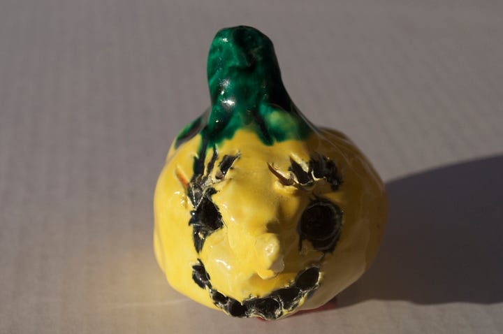 squash head, clay, sculpture, yellow face