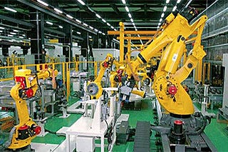 Yellow industrial robots in FANUC's robot factory in Japan
