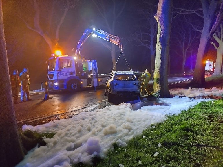 The burned wreck of the EV finally being towed by a tower outside of the jurisdiction.