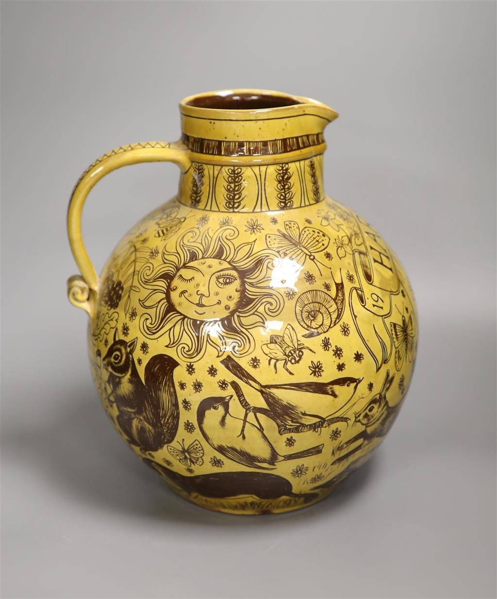 A pottery Harvest jug, dated 1971, made by Harry Juniper of Bideford, 1971, height 29cm A pottery Harvest jug, dated 1971, made by Harry Juniper of Bideford, 1971, height 29cm