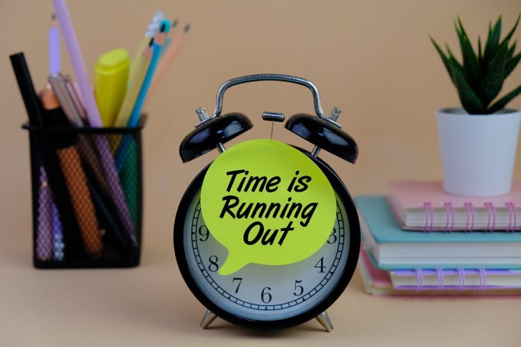 a clock with the text Time is Running Out on a white background. Suitable for urgency, deadlines, and time management themes.