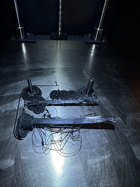 A custom 3D printer designed to look like solar punk, with black 3D printed anatomy models of reproductive organs.