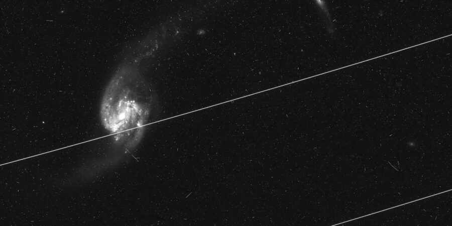 Satellite trail passes through galaxy Satellite trail passes through galaxy