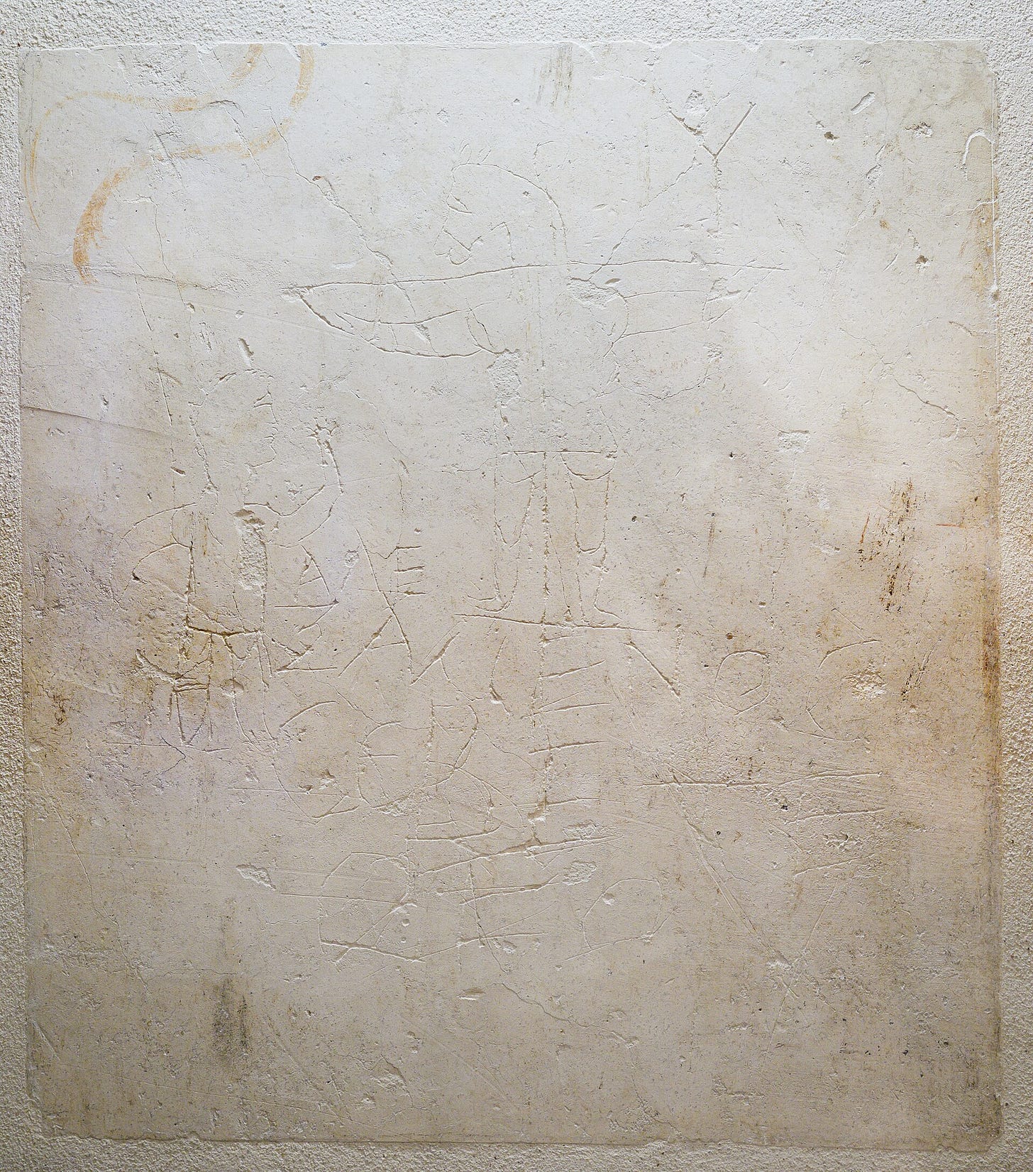 An ancient Roman graffito with a satirical depiction of Jesus Christ on a cross.
