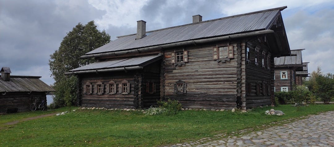 an old log house with a metal roof