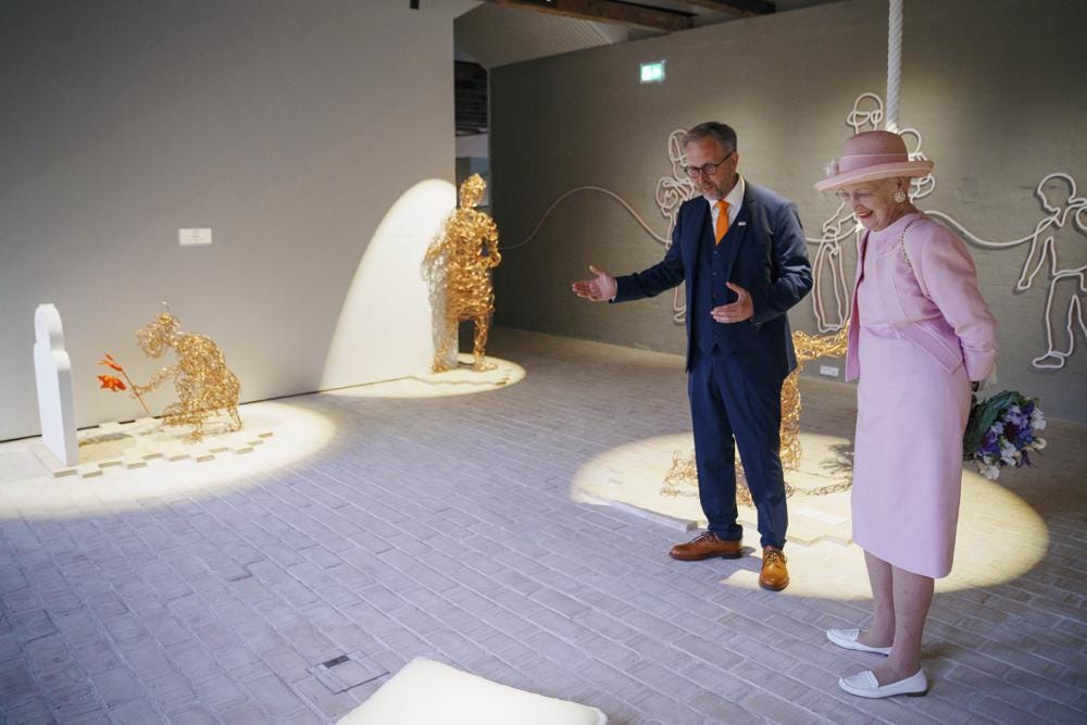 CORRECTS SPELLING OF NAME   The Danish Queen Margrethe and museum director Claus Kjeld Jensen walk during the  inauguration of the new museum Flugt, in Oksboel, Denmark, Saturday, June 25, 2022. Flugt — Refugee Museum of Denmark was created on the site of a camp in Oksboel, a town in southwestern Denmark, that housed up to 100,000 refugees from Germany in the postwar years. Flugt — which means escape in Danish — also tells the story of immigrants from Iran, Lebanon, Hungary, Vietnam and elsewhere who fled their homelands and found shelter in the Scandinavian country. (Bo Amstrup/Ritzau Scanpix via AP)
