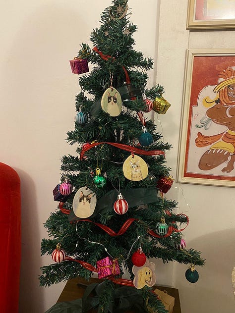 Ornaments on the tree, one comparing the portrait next to the actual dog