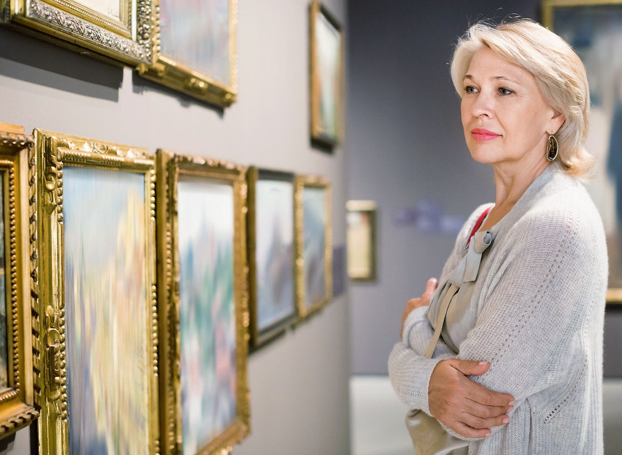 Woman looking at art in an art museum. Museums spark curiosity.