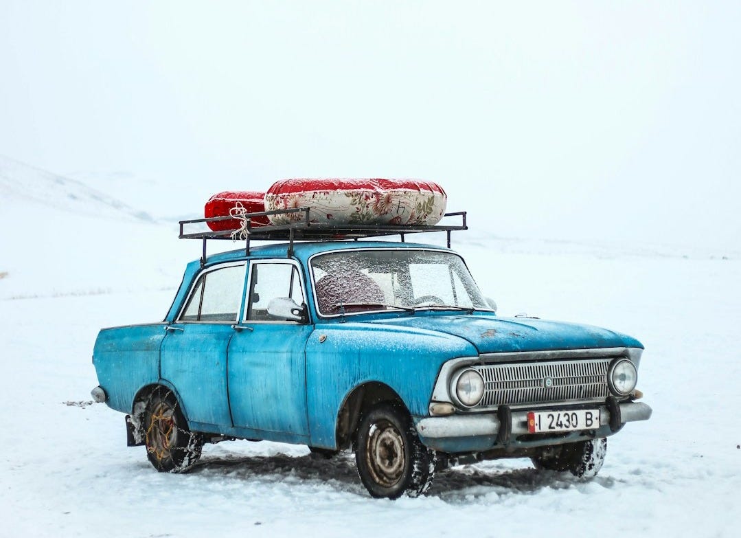 blue sedan on snow ground blue sedan on snow ground