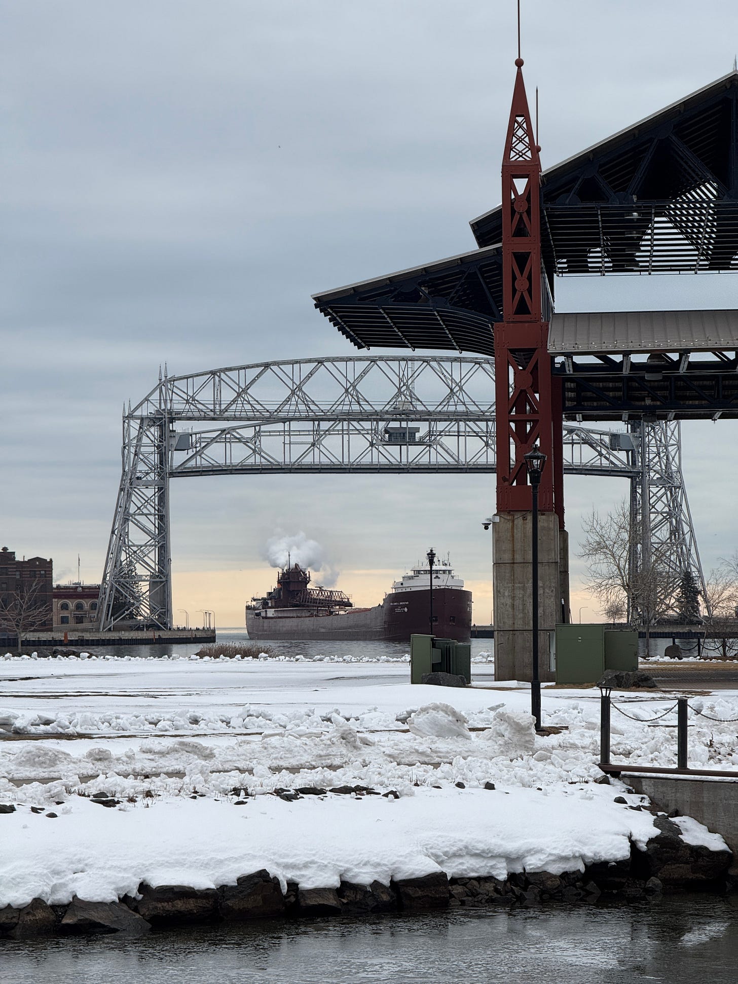 A ship coming in from Lake Superior to the St. Louis river bay beneath the arial lift bridge in Duluth, MN.