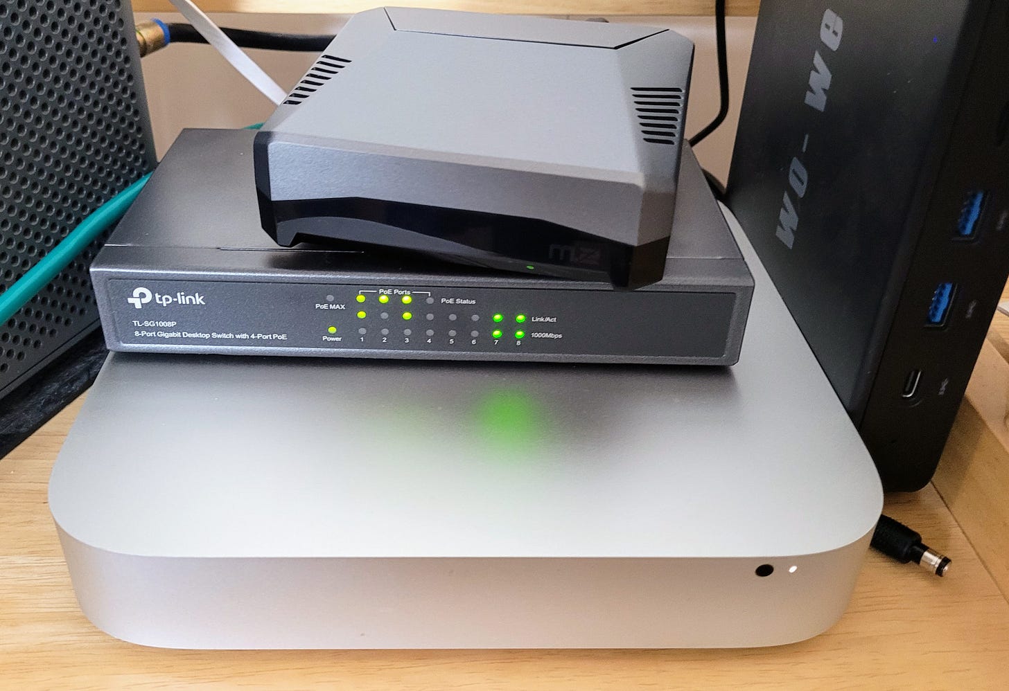 PoE switch and Raspberry Pi on top of Mac Mini 2014