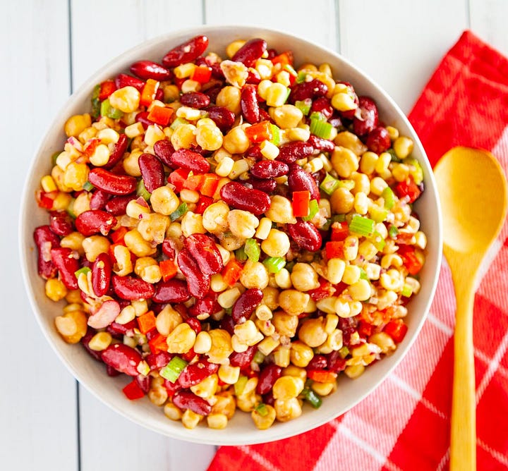 Corn and bean salad and a watermelon salad with strawberries.