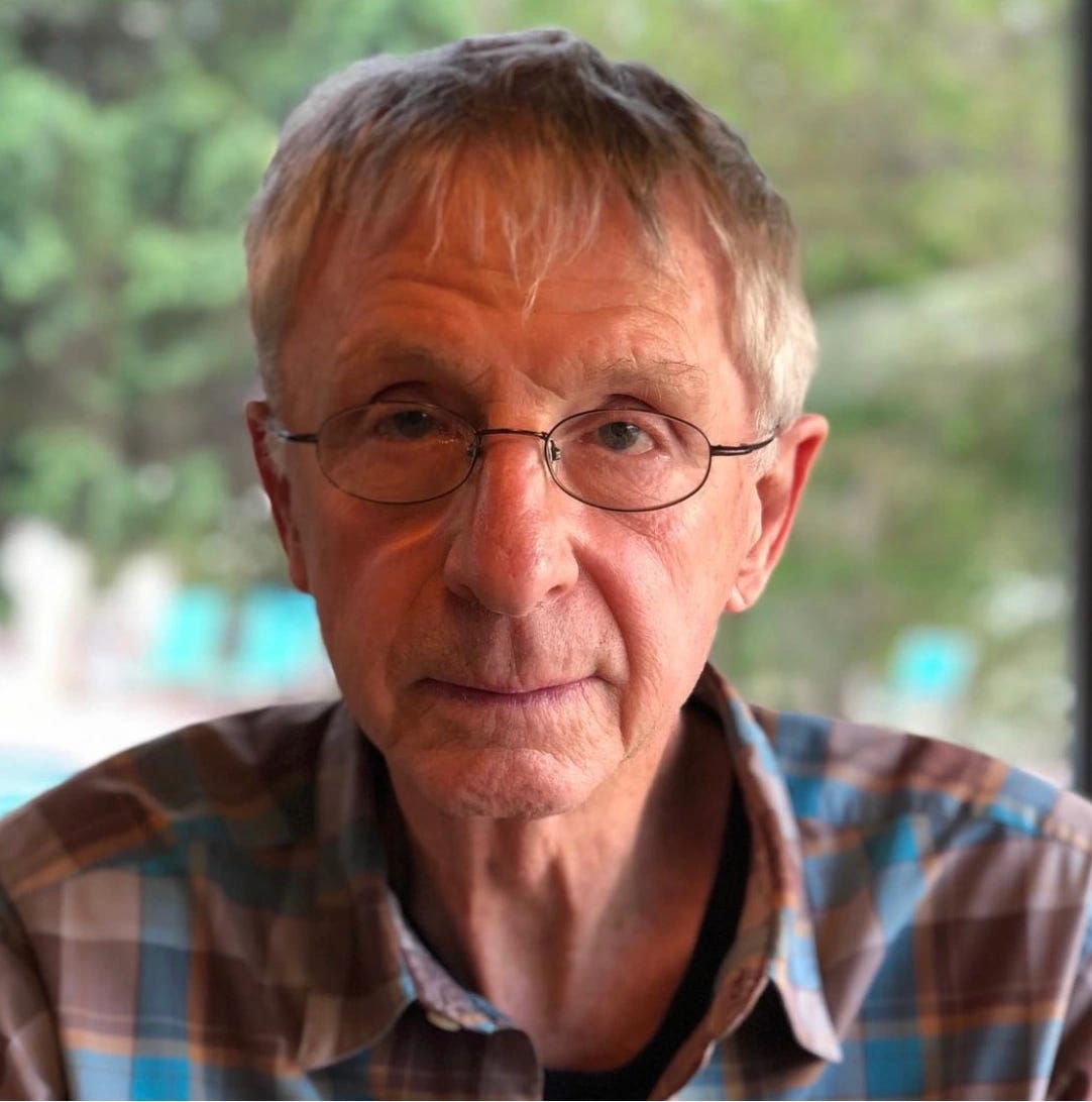 Color photo of a smiling older gentleman with glasses. Color photo of a smiling older gentleman with glasses.