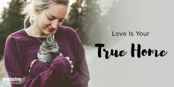 A blonde haired woman wears a sweater and holds a grey fluffy kitten in her arms. Text Overlay: Love Is Your True Home A blonde haired woman wears a sweater and holds a grey fluffy kitten in her arms. Text Overlay: Love Is Your True Home