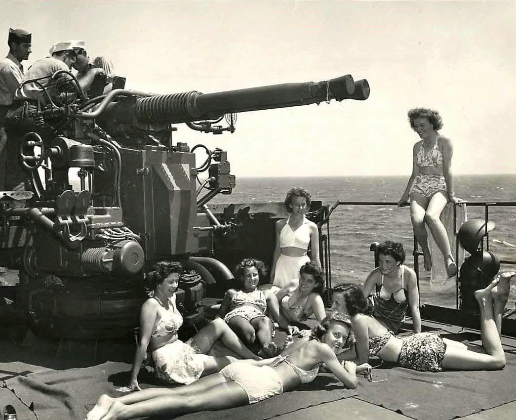Army nurses soak up the sun next to a twin Bofors 40 mm gun aboard a US Coast Guard troop ship returning from Europe, 1945. Said nurse Clara Hensley, “After years of chaos, the sun felt like a victory hug — all I recalled thinking is 'we're going home!'" Army nurses soak up the sun next to a twin Bofors 40 mm gun aboard a US Coast Guard troop ship returning from Europe, 1945. Said nurse Clara Hensley, “After years of chaos, the sun felt like a victory hug — all I recalled thinking is 'we're going home!'"