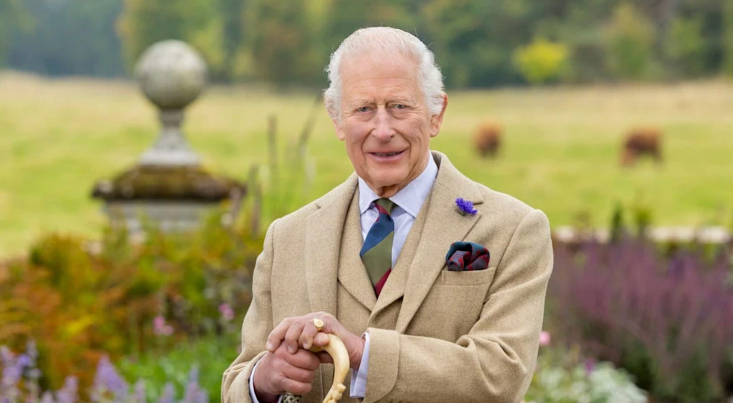 King Charles smiling with a walking stick