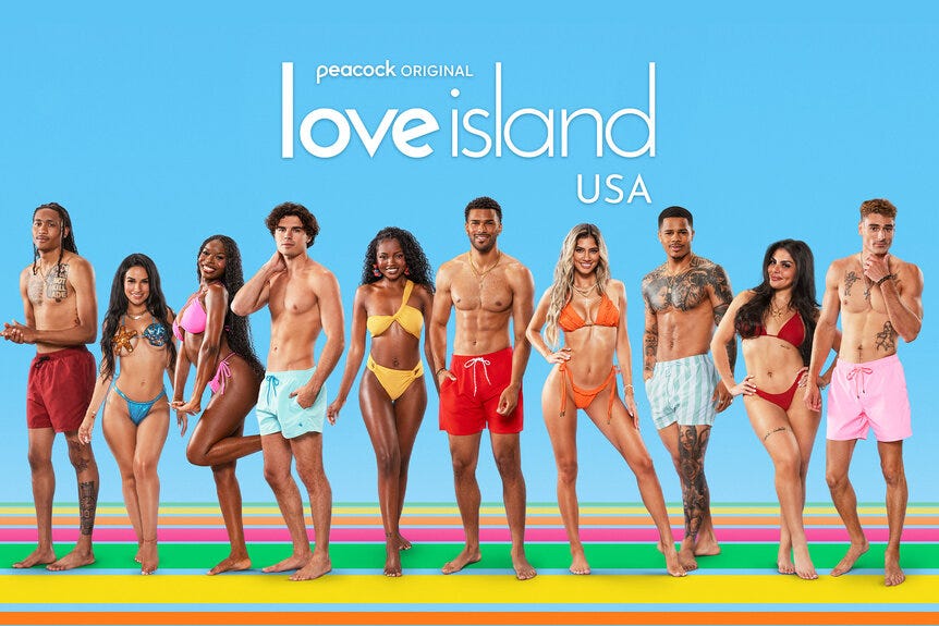 The cast of Love Island USA Season 7 smile in bathing suits.
