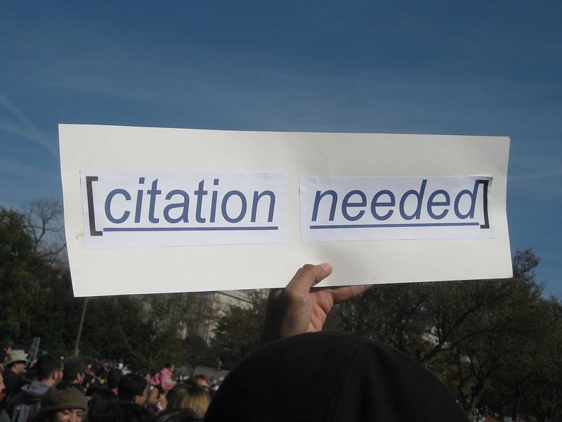 A sign that reads "citation needed" held up at a rally in Washington, DC. A sign that reads "citation needed" held up at a rally in Washington, DC.