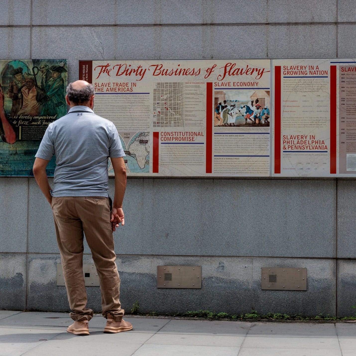 A person standing in front of a sign

AI-generated content may be incorrect.