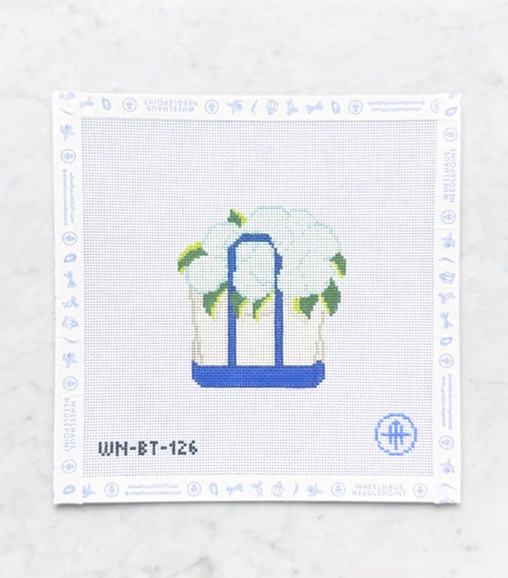 needlepoint canvases of boat and tote, sour dough starter, slice of cake and butterfly clips