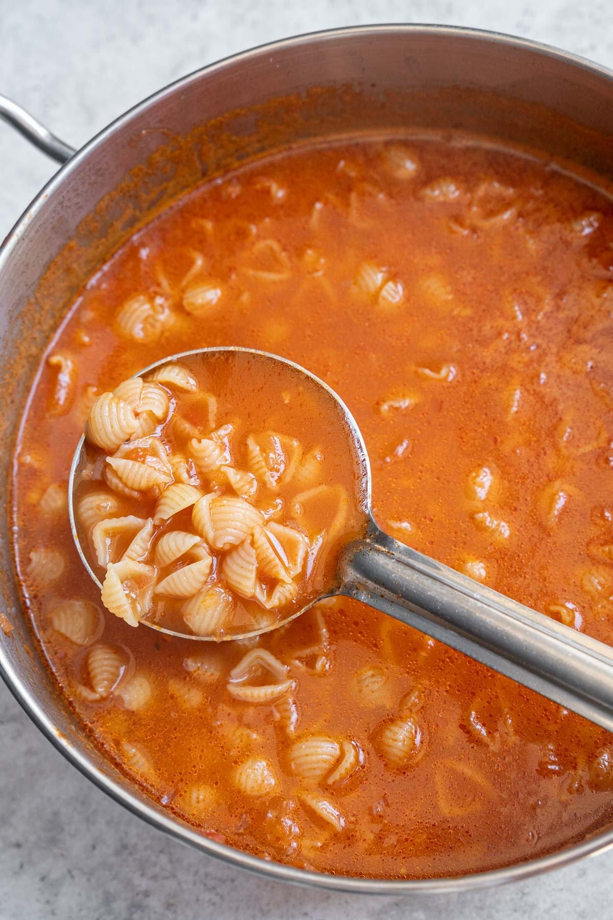 Cooking the shell pasta in the tomato broth