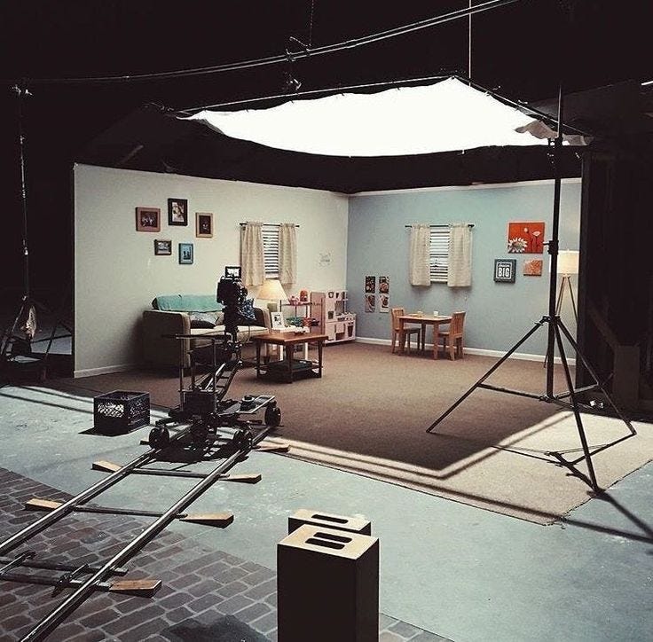 This may contain: a camera set up in the middle of a room with chairs and other items on the floor