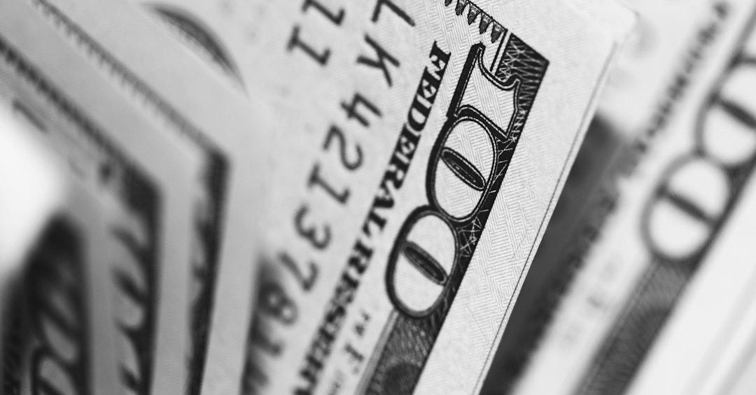 closeup photo of 100 US dollar banknotes closeup photo of 100 US dollar banknotes