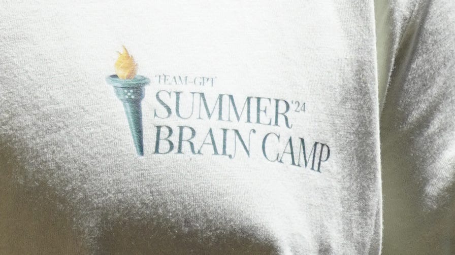 A white t-shirt with a logo

Description automatically generated