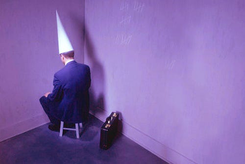 businessman-sitting-in-corner-with-dunce-hat | Bankruptcy Attorney  Bakersfield - Max Gardner