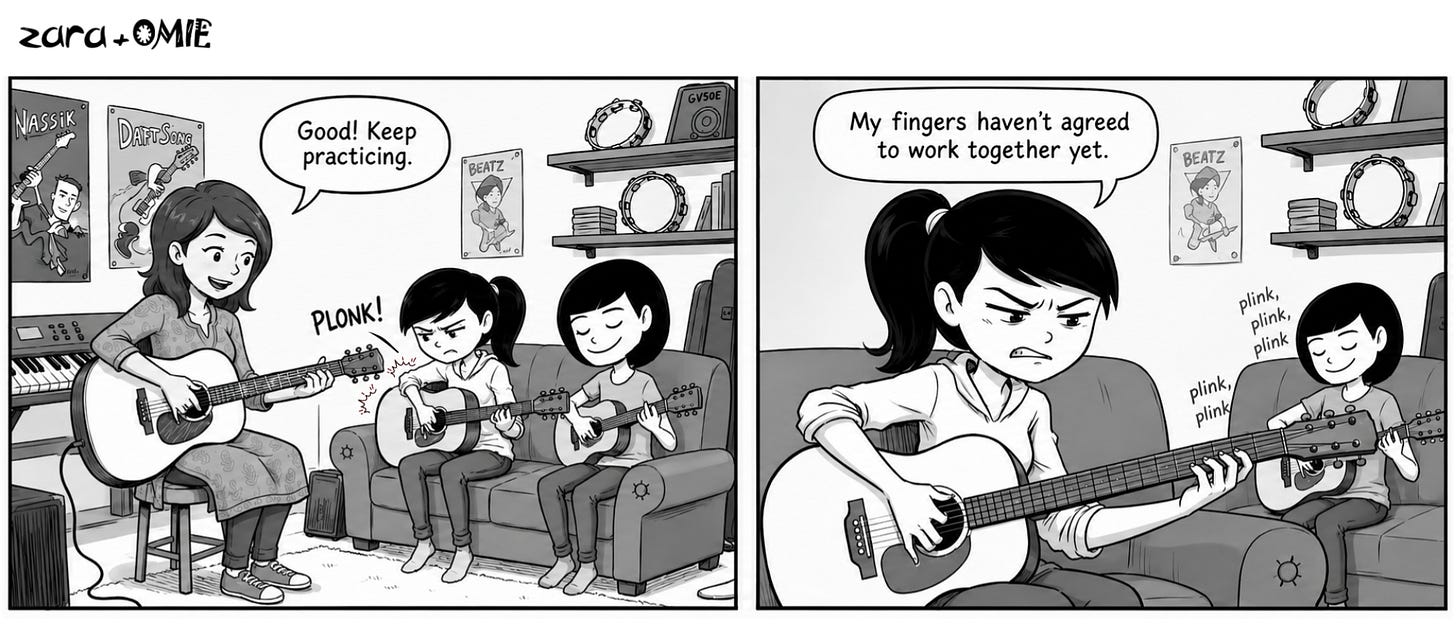 During a guitar lesson, Misha plays smoothly while Zara struggles with her first chord and jokes that her fingers haven’t agreed to work together yet.
