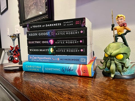 Meeting Christina Lauren, a signed copy of Something Wilder, and a stack of romance books I had signed