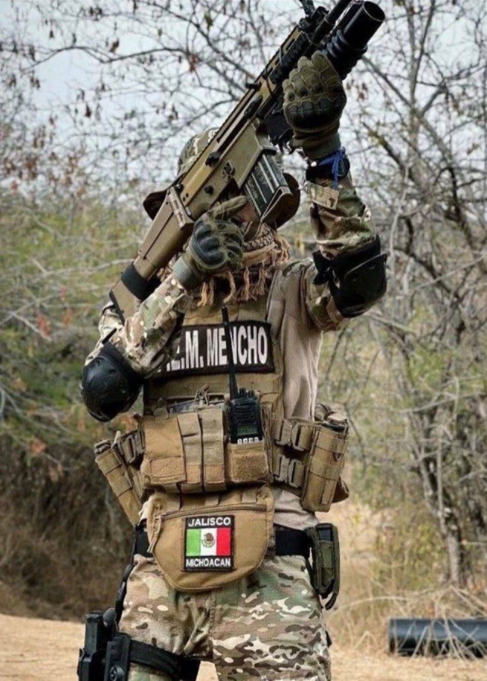 A CJNG “Mencho Special Forces” member takes aim at a drone operated by a rival cartel A CJNG “Mencho Special Forces” member takes aim at a drone operated by a rival cartel