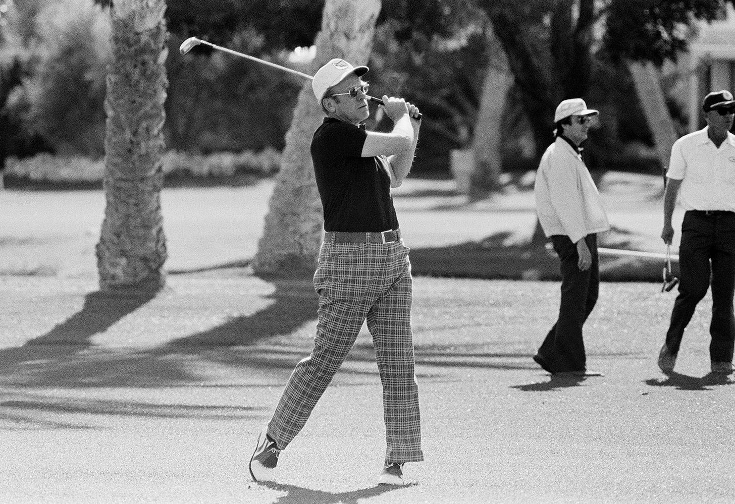 President Gerald Ford effortlessly escapes a sand trap at Eldorado Country Club while golfing with comedian Bob Hope during a working vacation in Palm Springs, California, March 31, 1975. President Gerald Ford effortlessly escapes a sand trap at Eldorado Country Club while golfing with comedian Bob Hope during a working vacation in Palm Springs, California, March 31, 1975.