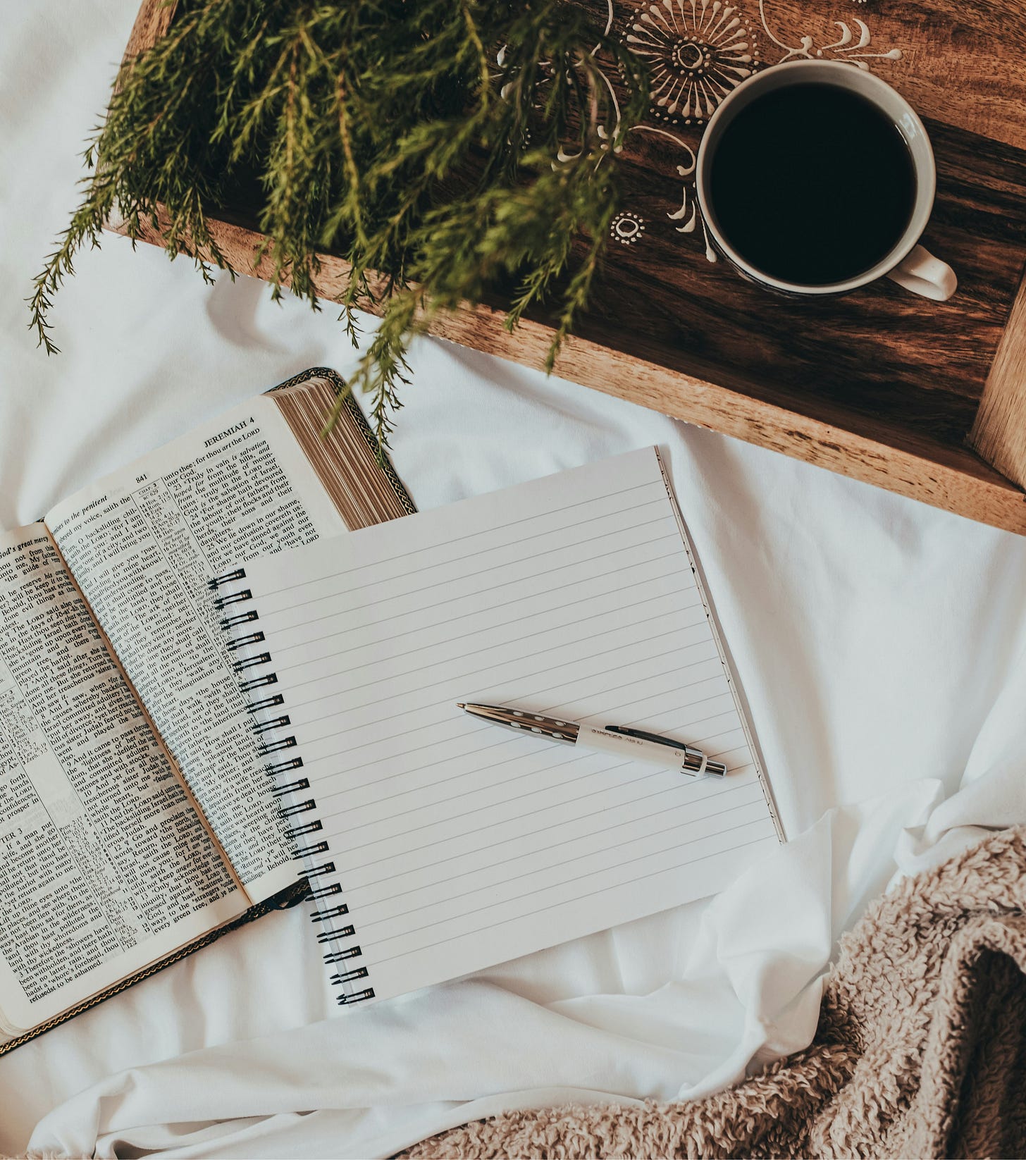 image of a notebook on a bed with coffee image of a notebook on a bed with coffee