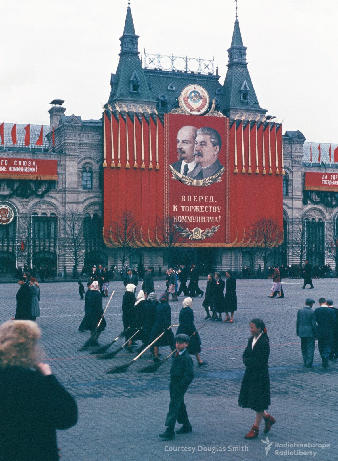 An iconic scene on Red Square: streetcleaners diligently wielding traditional tree-branch brooms, maintaining Moscow's historic heart. An iconic scene on Red Square: streetcleaners diligently wielding traditional tree-branch brooms, maintaining Moscow's historic heart.