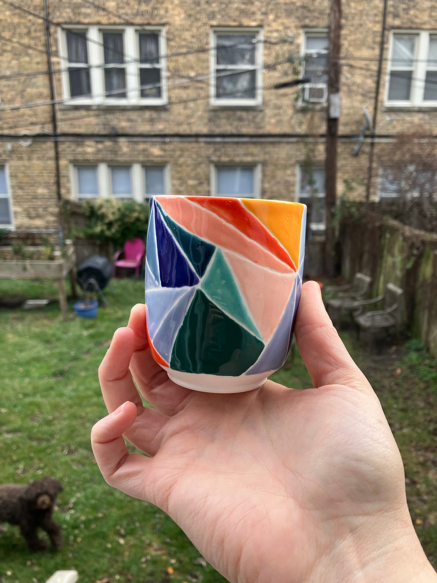 multicolored porcelain cup made to resemble stained glass in the sunlight