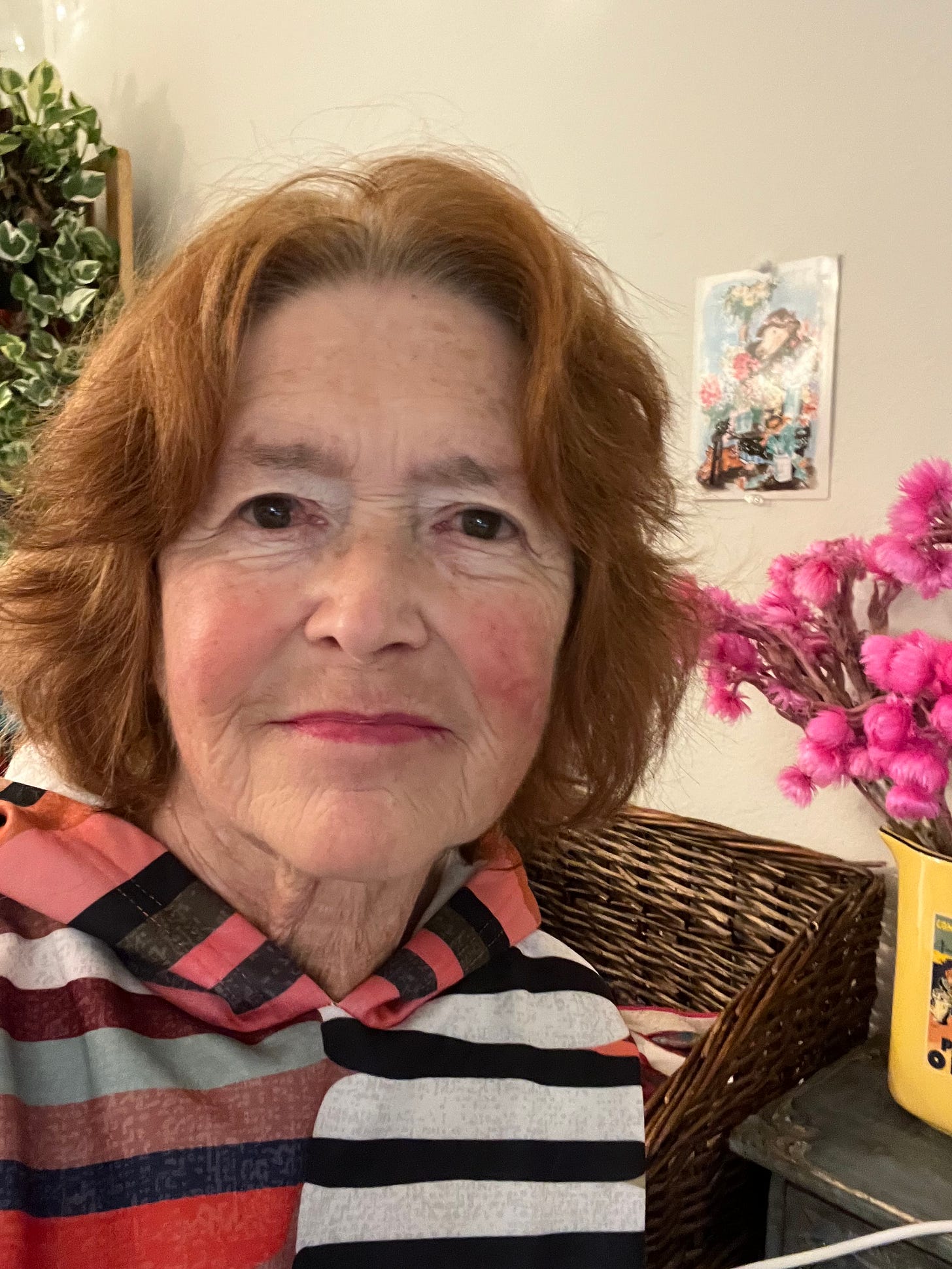 Headshot of Rachel Zemach: a white woman with short brown hair smiles gently into the camera, wearing a comfy striped shirt. An assortment of bright plants sits on a shelf in the background. Headshot of Rachel Zemach: a white woman with short brown hair smiles gently into the camera, wearing a comfy striped shirt. An assortment of bright plants sits on a shelf in the background.
