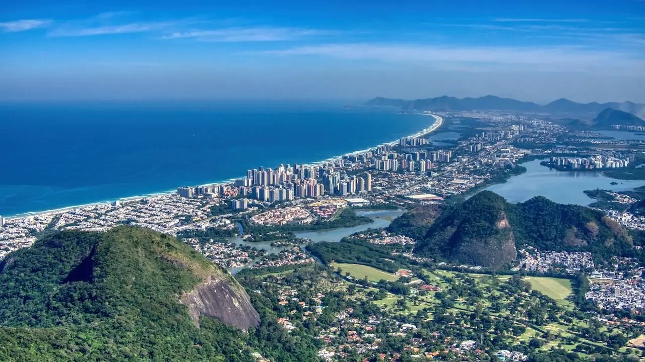 View of a lake, high rise buildings, beaches and sea from above