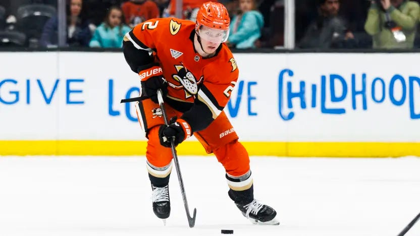 Jackson LaCombe carries the puck